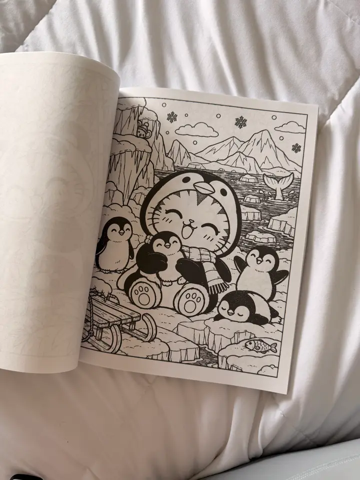 A photo of a printed coloring page showing Sassy in a penguin costume surrounded by penguins on the ice.